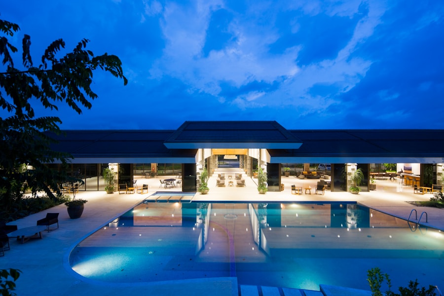 blue body of water in front of building near trees during nighttime